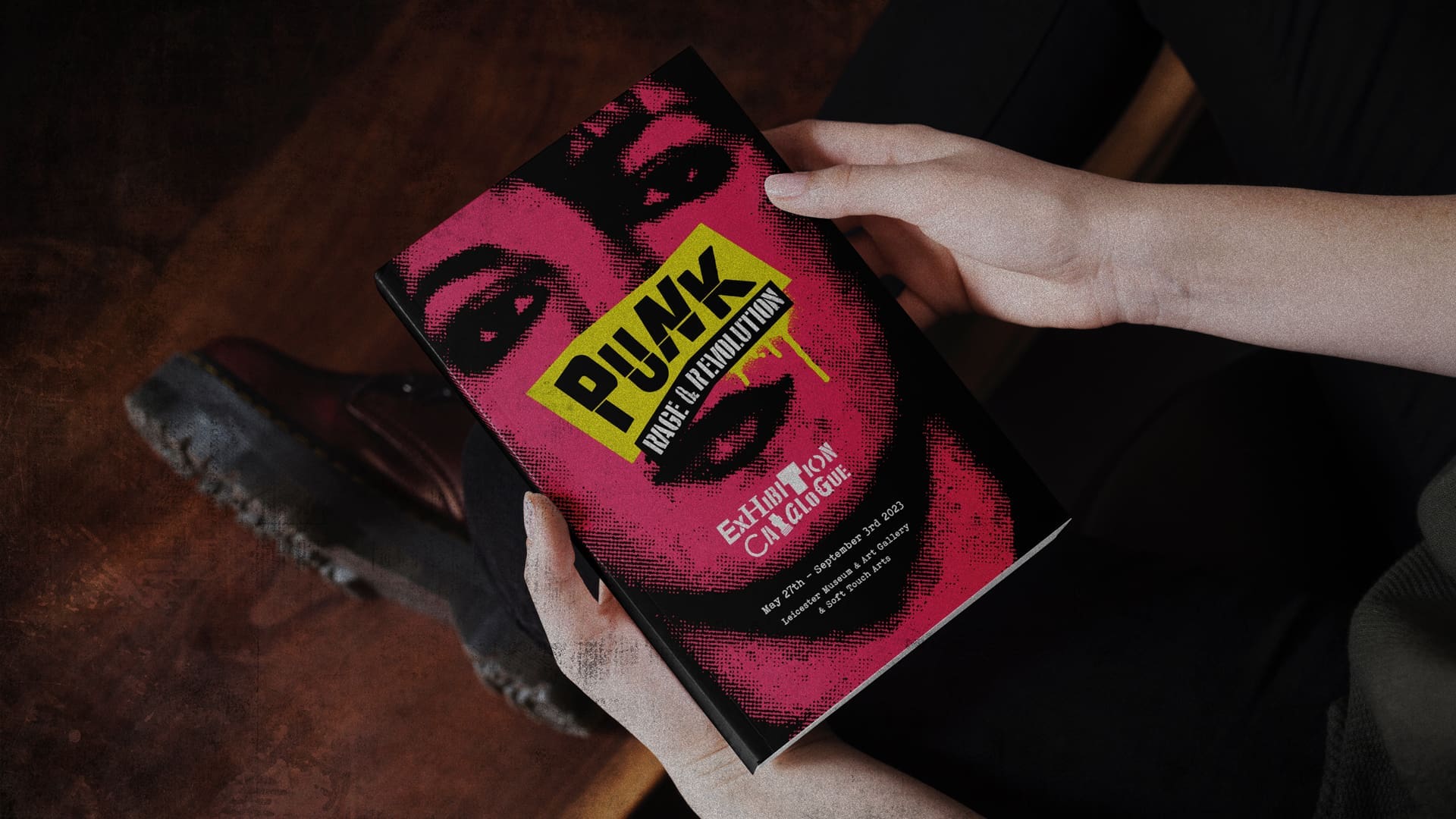 Hands holding a Punk: Rage and Revolution Exhibition Catalogue