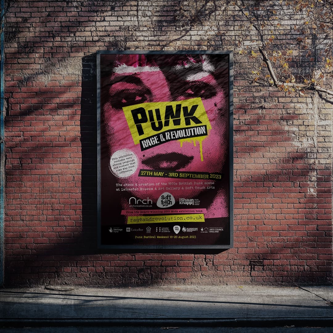 Poster for the Punk: Rage and Revolution Exhibition pasted to a brick wall