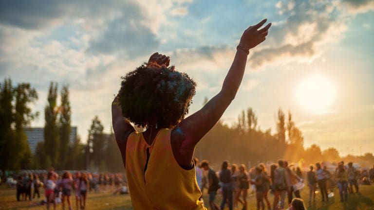 Young black woman dancing at summer holi festival