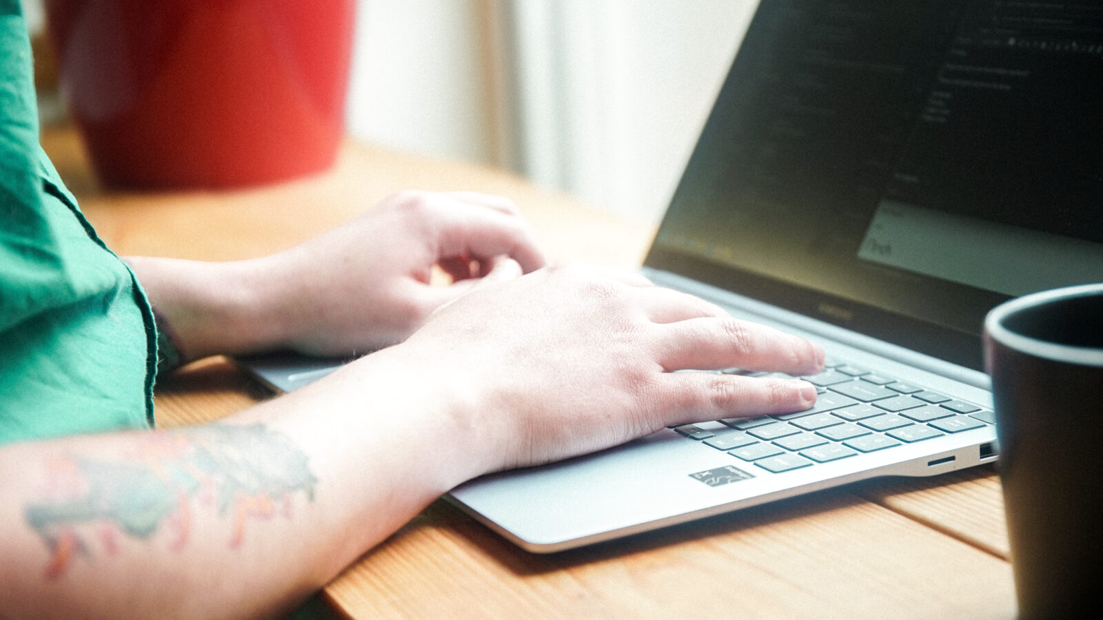 Close up of Account Manager, Josh, typing on laptop keyboard