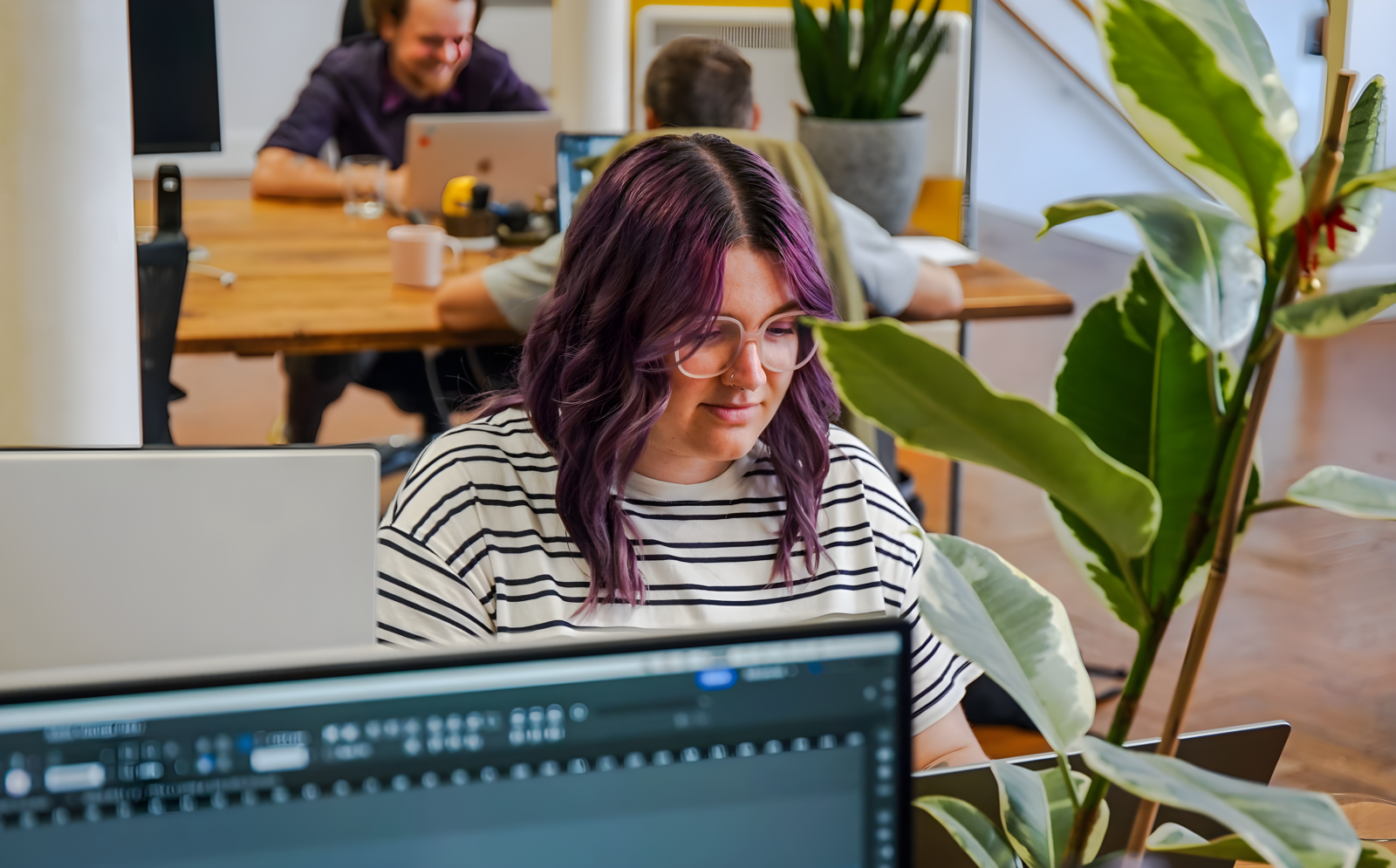 Senior Designer, Sarah, working at her desk