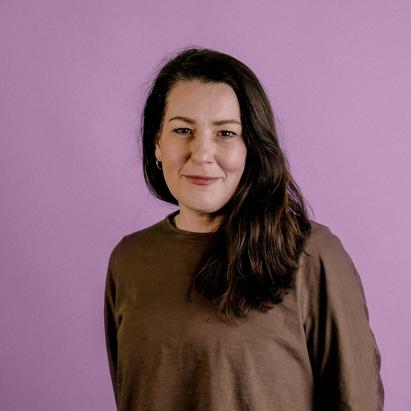 Headshot of Natasha Nixon, Accounts, on pink background